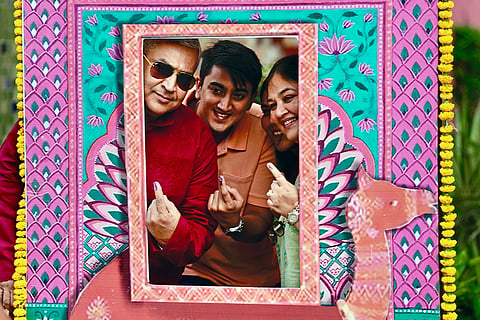 Voters pose at a selfie kiosk